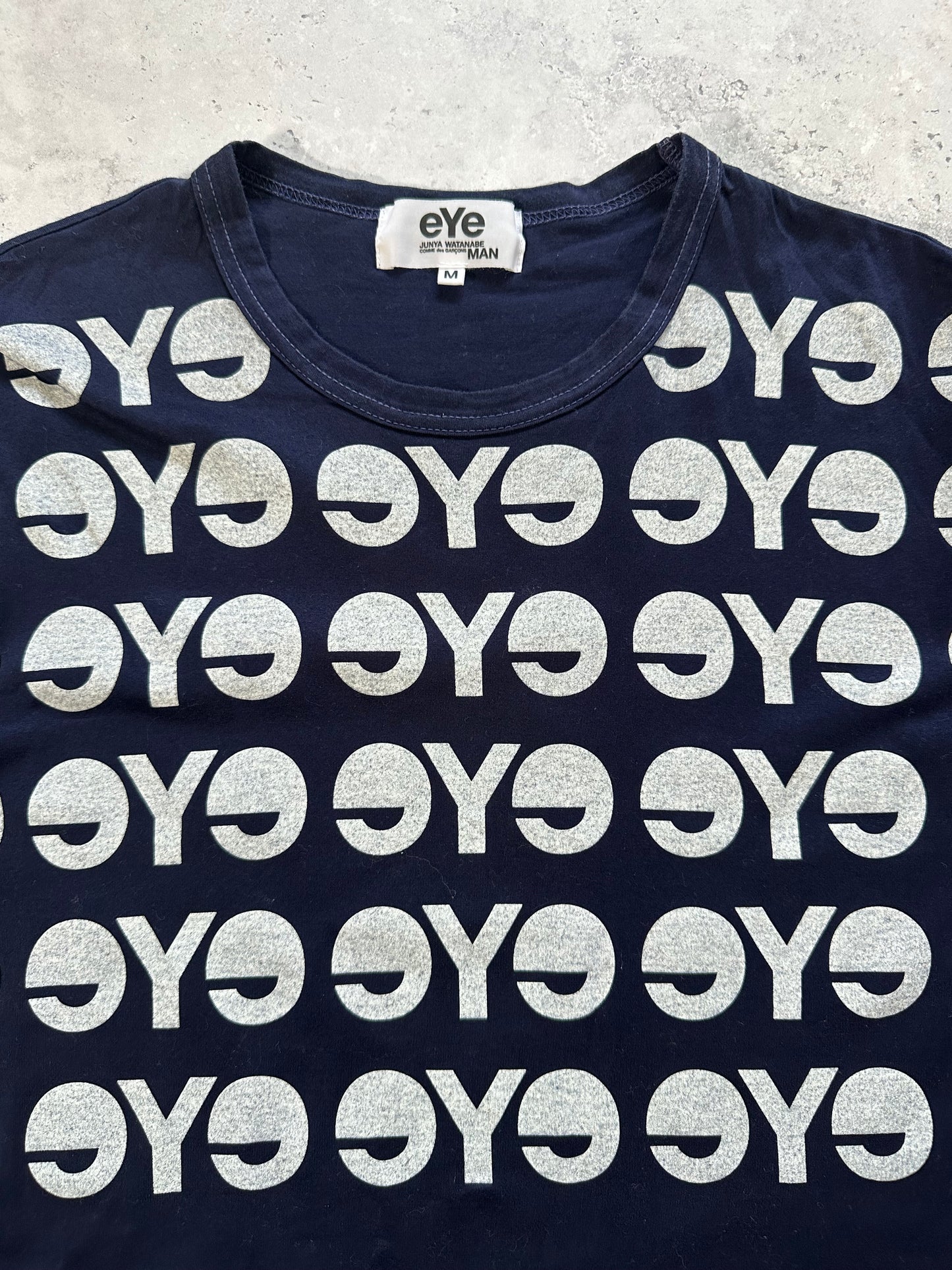 eYe Junya Watanabe MAN COMME des GARÇONS AD2012 All-Over Logo Print T-Shirt